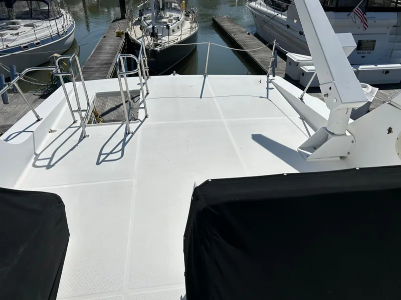 Slide: The Image of Bayliner 4788 1994 yacht deck with marina view and docked boats. - 3