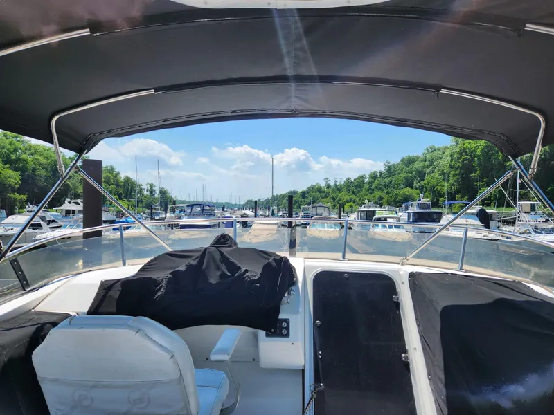 Slide: The Image of 1994 Bayliner 4788 yacht docked at a marina, view from the cockpit. - 6