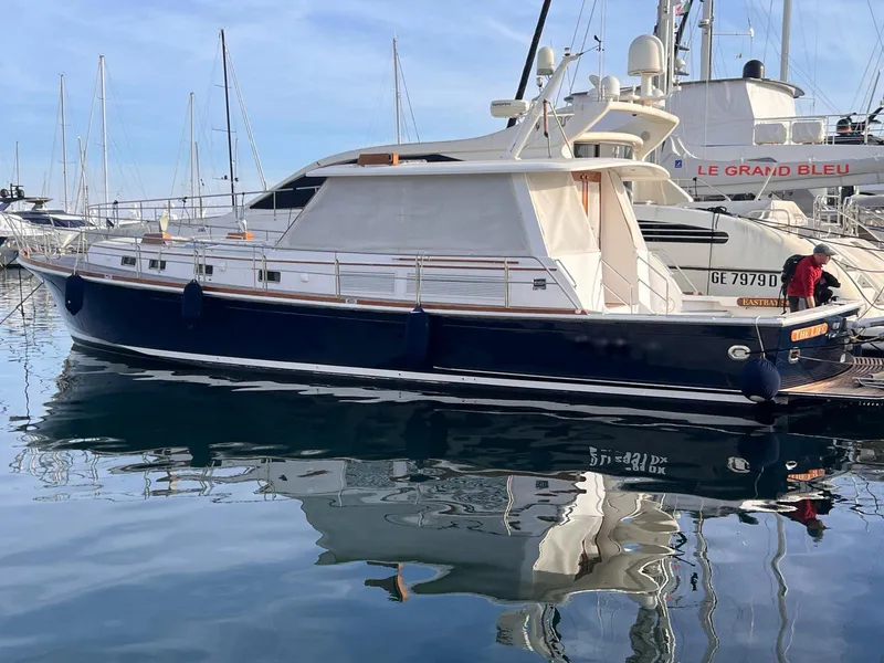 Slide: The Image of 2004 Grand Banks Eastbay 54 SX yacht docked in marina, reflecting on calm water. - 0