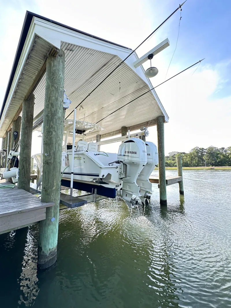 Slide: The Image of 2019 Jupiter 30 HFS boat docked under a covered pier. - 12