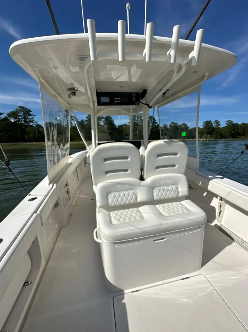 Slide: The Image of 2019 Jupiter 30 HFS boat interior with white seating and rod holders. - 15