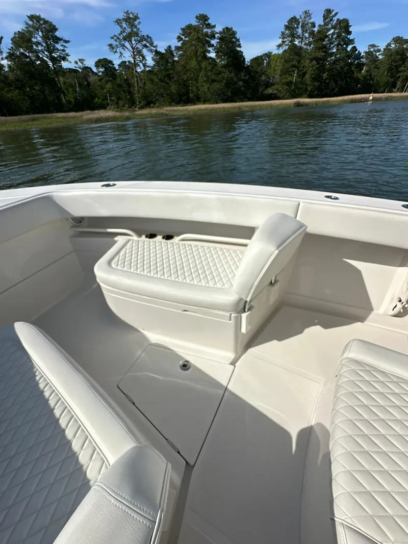 Slide: The Image of 2019 Jupiter 30 HFS boat with white cushioned seating on a calm lake. - 16