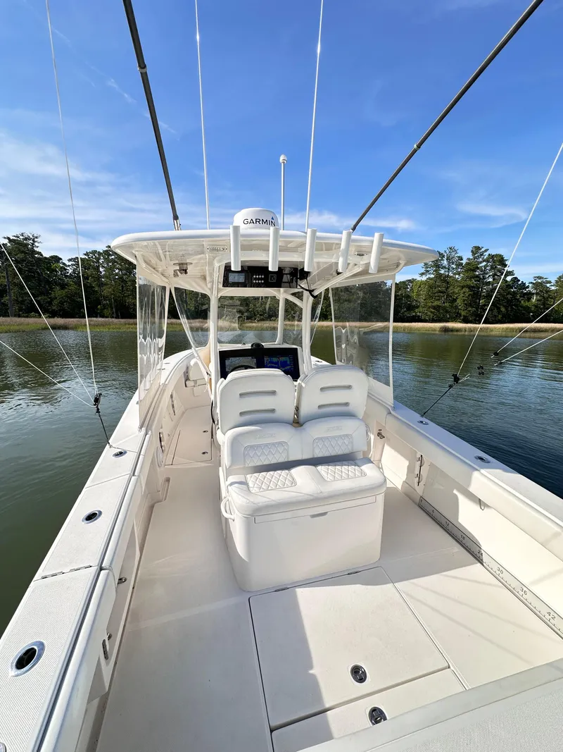 Slide: The Image of 2019 Jupiter 30 HFS boat on calm water, featuring spacious deck and seating. - 20