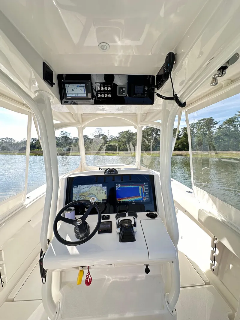 Slide: The Image of 2019 Jupiter 30 HFS boat cockpit with modern navigation equipment and scenic water view. - 21