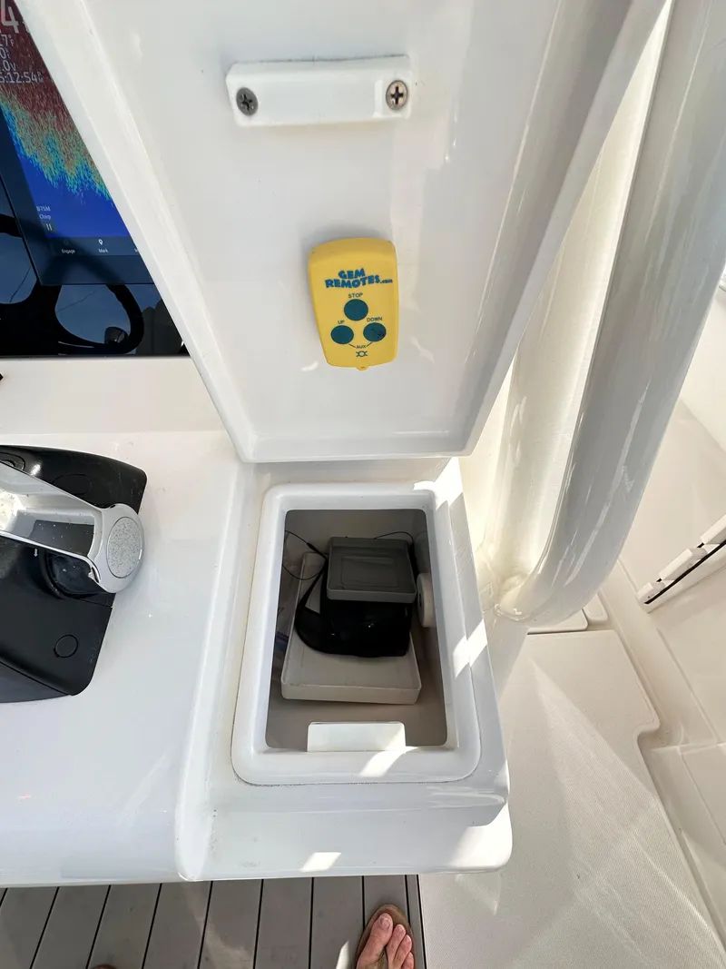 Slide: The Image of 2019 Jupiter 30 HFS boat control panel with storage compartment. - 24