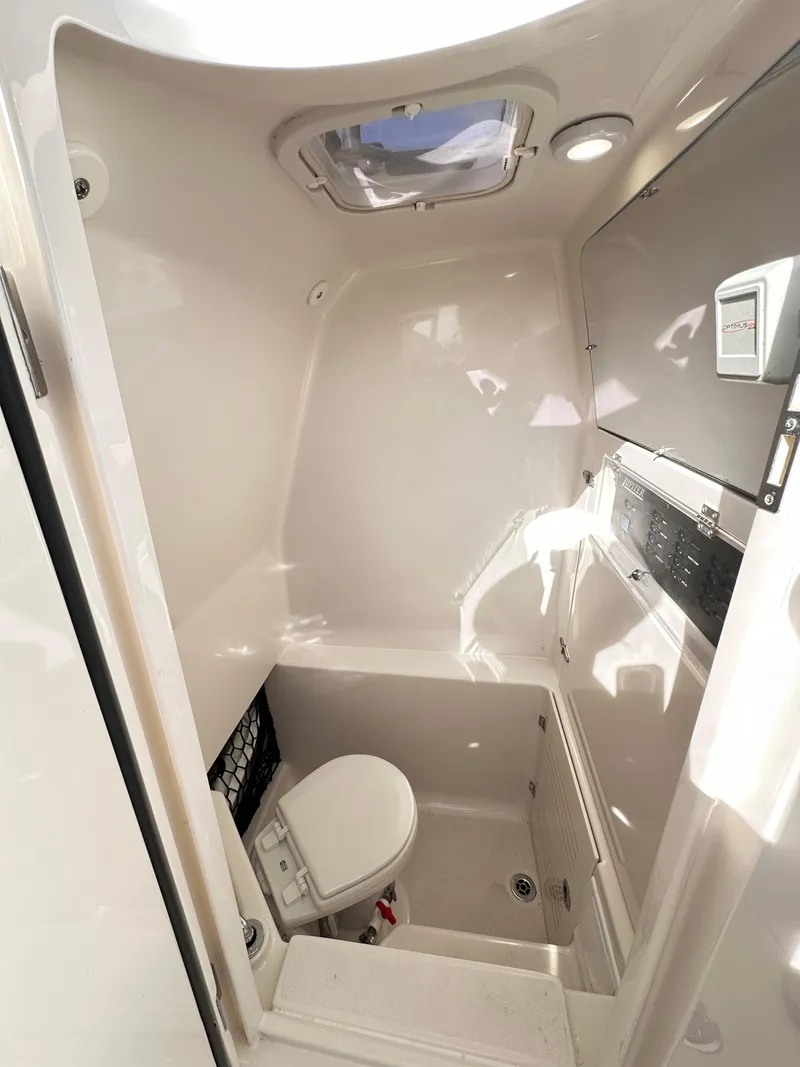 Slide: The Image of 2019 Jupiter 30 HFS boat interior with compact bathroom and toilet. - 27