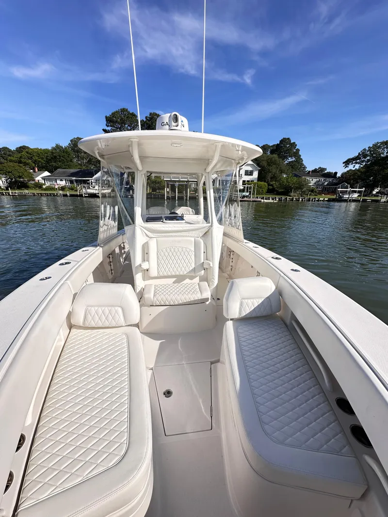 Slide: The Image of 2019 Jupiter 30 HFS boat with white seating, on a calm lake under blue skies. - 28