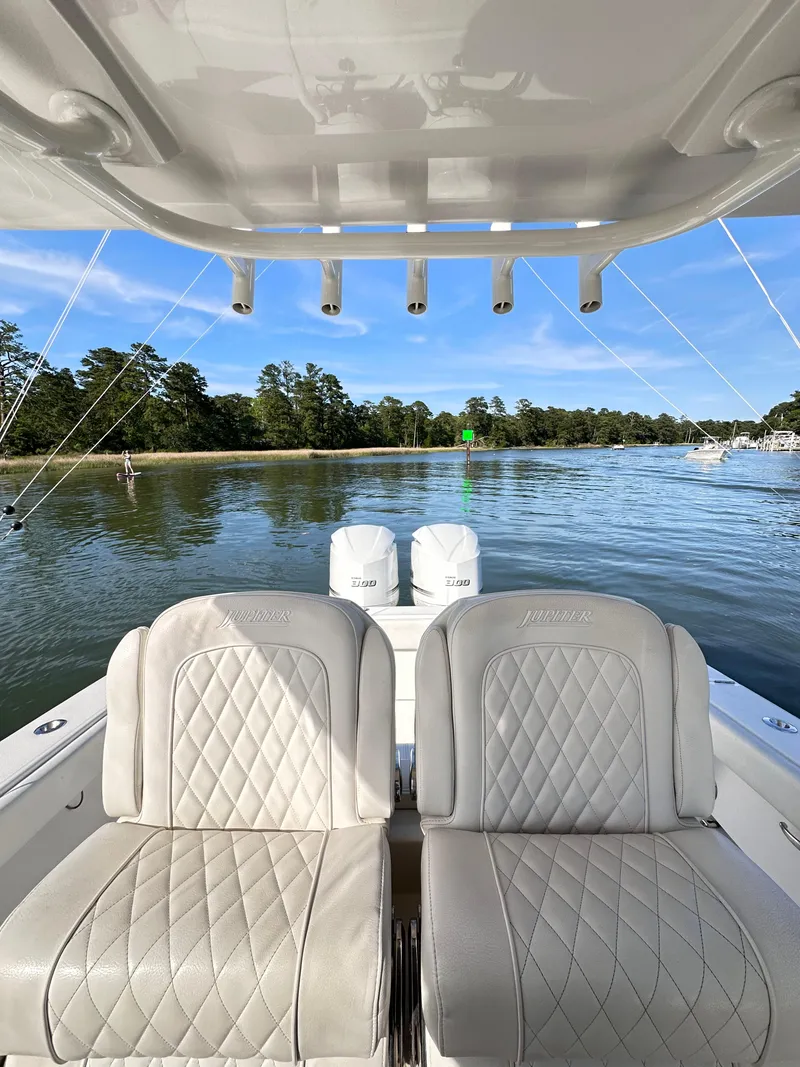 Slide: The Image of 2019 Jupiter 30 HFS boat with dual engines on a serene lake. - 33