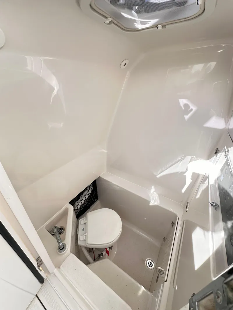 Slide: The Image of 2019 Jupiter 30 HFS boat interior with compact marine toilet. - 34