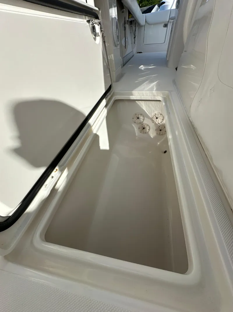 Slide: The Image of 2019 Jupiter 30 HFS boat storage compartment, open and empty, with white interior. - 39