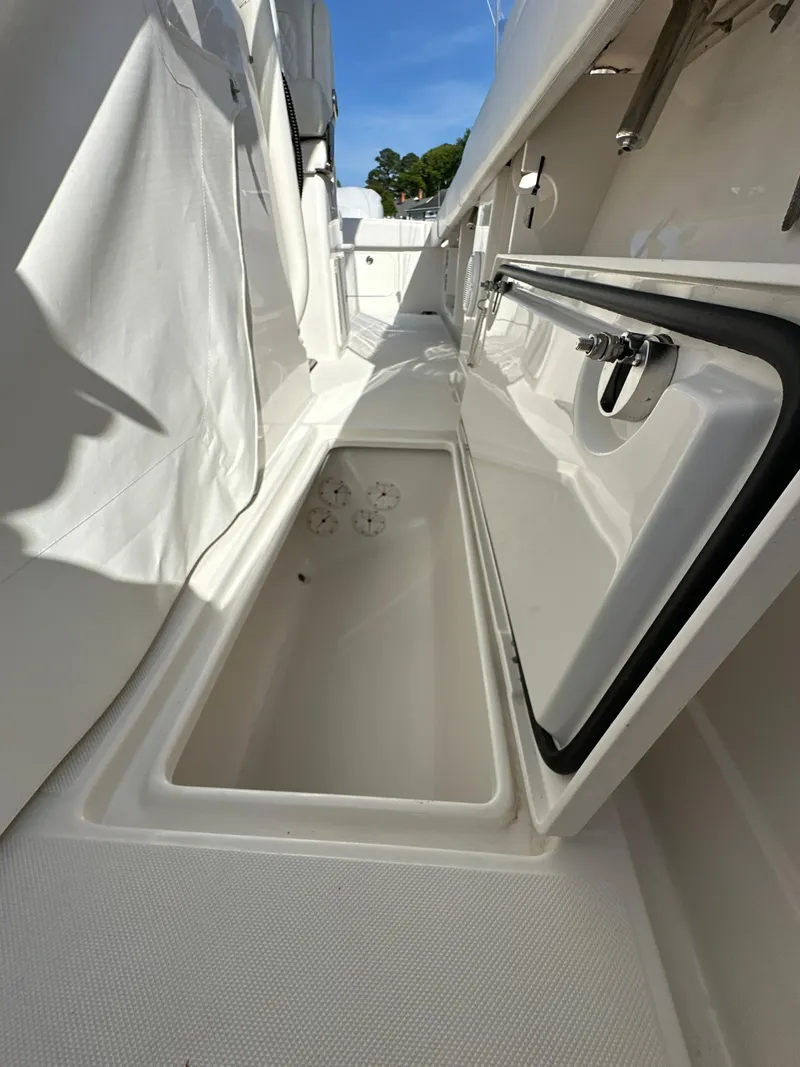 Slide: The Image of 2019 Jupiter 30 HFS boat storage compartment with open hatch, white interior. - 40
