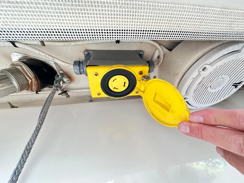 Slide: The Image of Yellow power outlet on 2019 Jupiter 30 HFS boat, hand opening cover. - 43