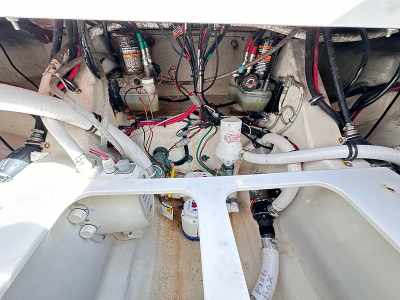 Slide: The Image of 2019 Jupiter 30 HFS boat engine compartment with wiring and hoses. - 49