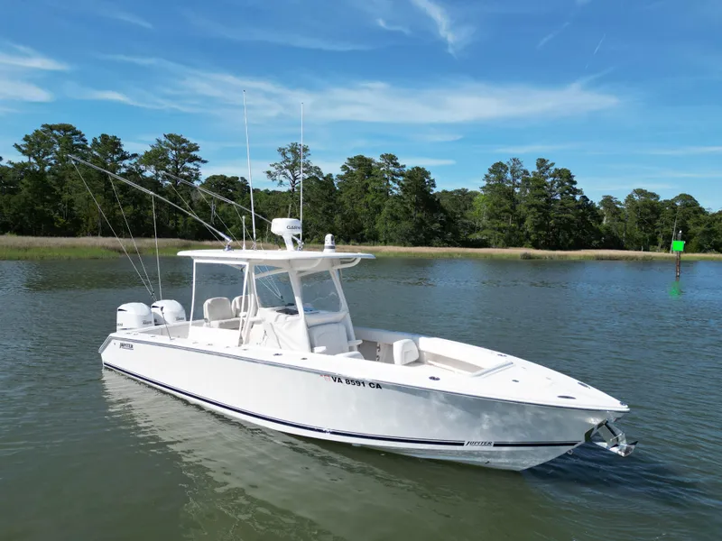 Slide: The Image of 2019 Jupiter 30 HFS boat on calm water with trees in background. - 7