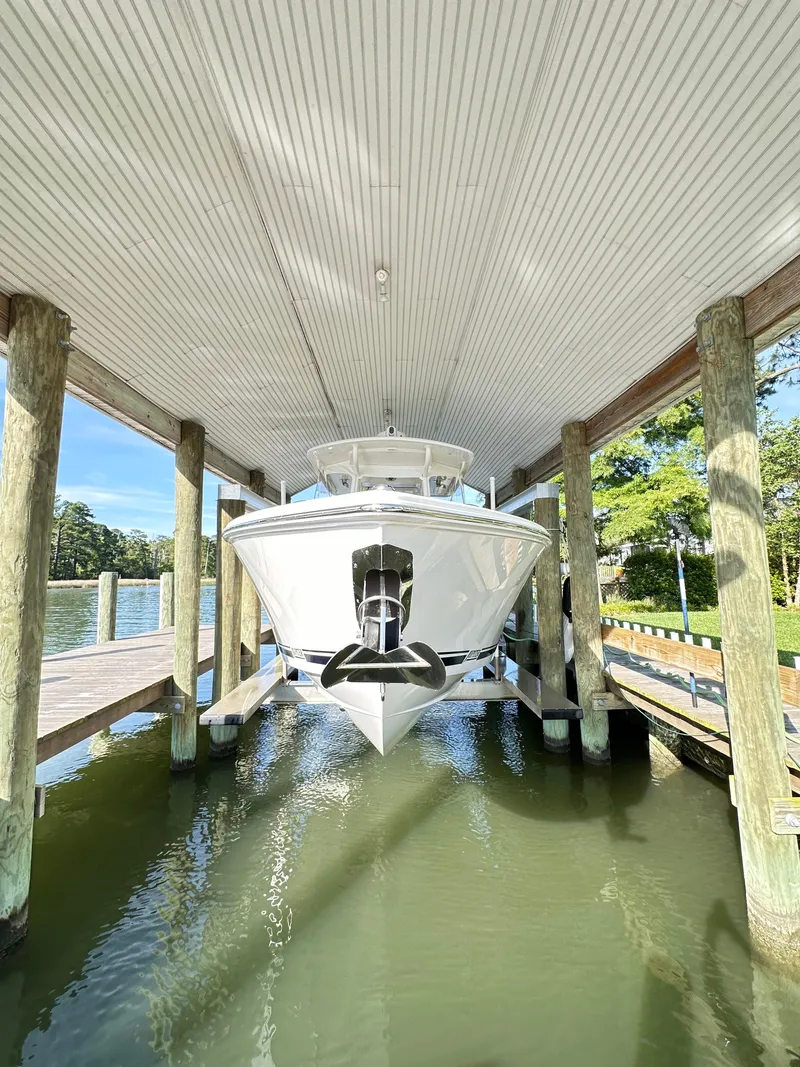 Slide: The Image of 2019 Jupiter 30 HFS boat docked under covered pier. - 9