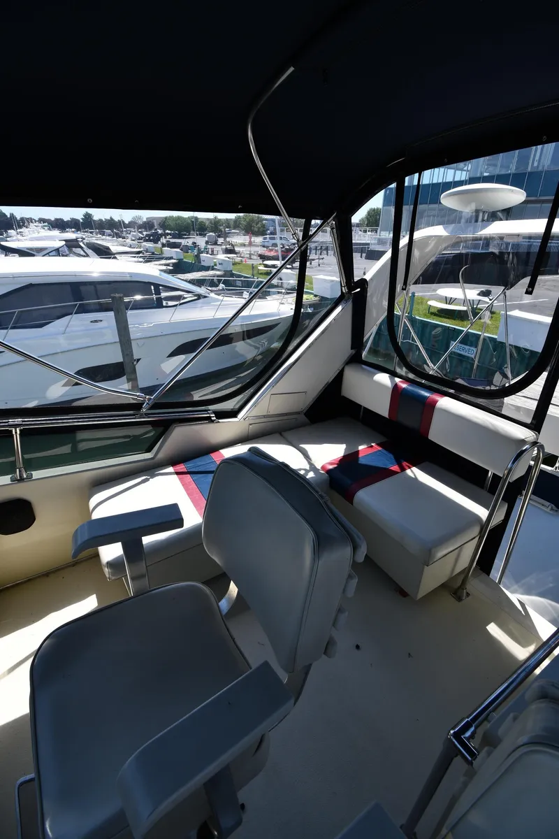 Slide: The Image of 1988 Tollycraft 34 Sundeck interior with seating and helm station. - 26