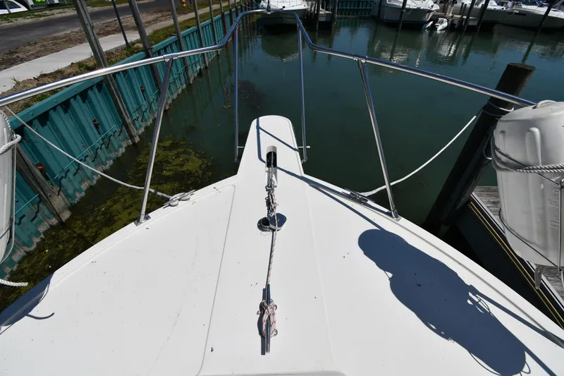 Slide: The Image of 1988 Tollycraft 34 Sundeck bow view at dock, showing anchor and railings. - 4