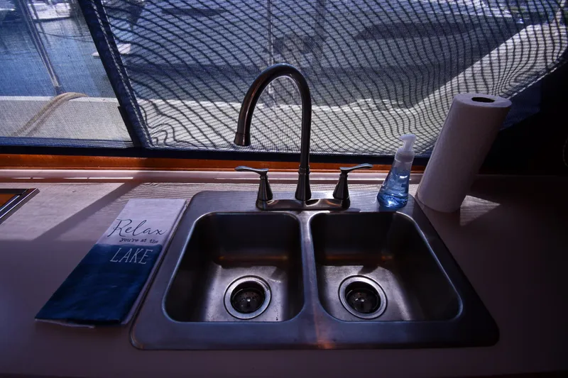 Slide: The Image of 1988 Tollycraft 34 Sundeck kitchen sink with faucet, paper towel, and hand soap. - 44