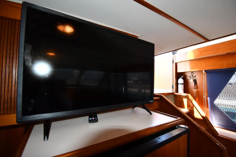 Slide: The Image of Flat-screen TV in the cabin of a 1988 Tollycraft 34 Sundeck yacht. - 48