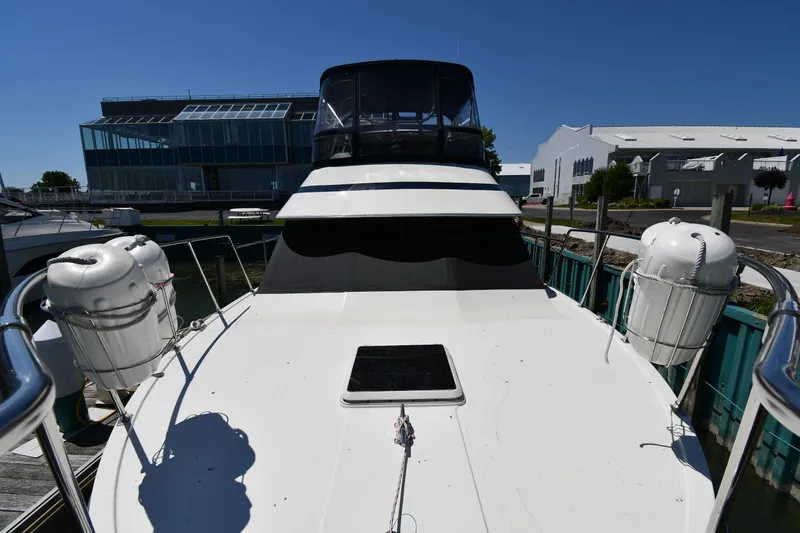 Slide: The Image of 1988 Tollycraft 34 Sundeck yacht docked at marina, front deck view. - 5