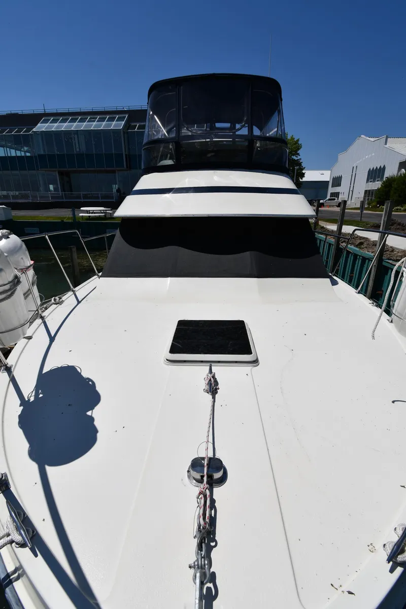 Slide: The Image of 1988 Tollycraft 34 Sundeck yacht docked at marina. - 6