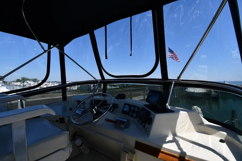 Slide: The Image of Interior helm of 1988 Tollycraft 34 Sundeck yacht with marina view. - 14