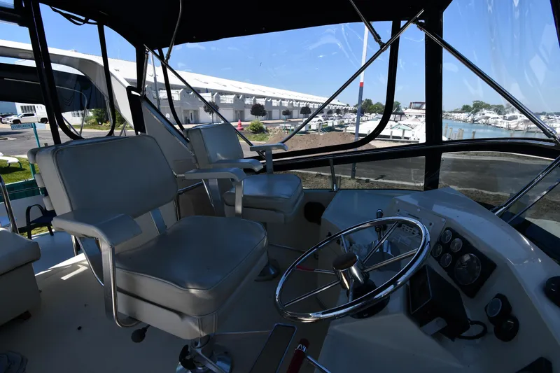 Slide: The Image of 1988 Tollycraft 34 Sundeck boat interior with helm and seating. - 19