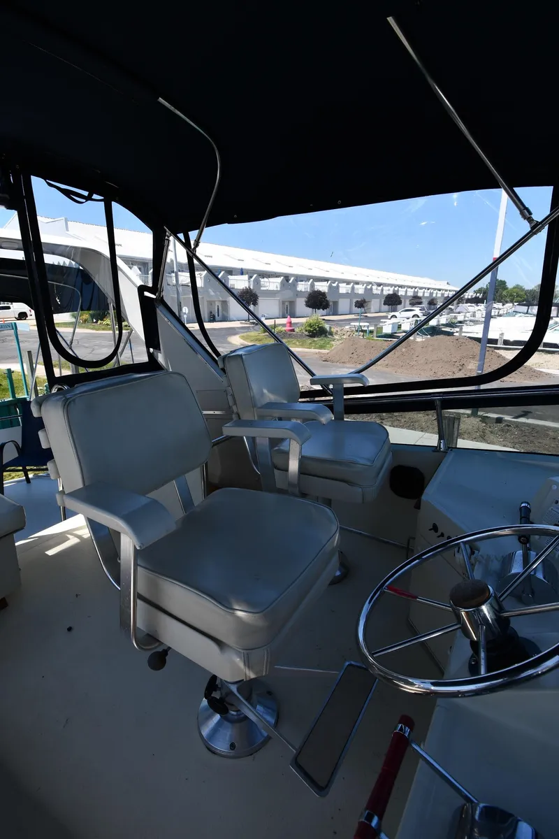 Slide: The Image of 1988 Tollycraft 34 Sundeck boat interior with helm and seating. - 20