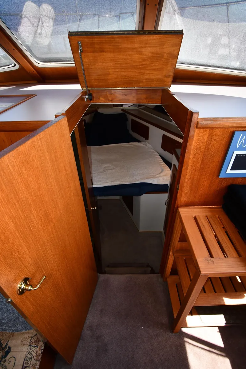 Slide: The Image of Interior cabin view of 1988 Tollycraft 34 Sundeck yacht with wooden finishes. - 28