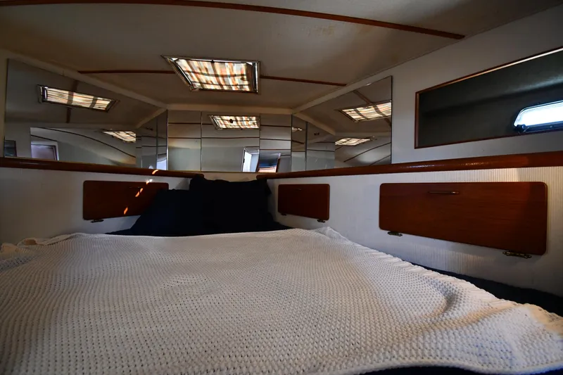 Slide: The Image of Interior cabin of 1988 Tollycraft 34 Sundeck with bed and mirrors. - 29