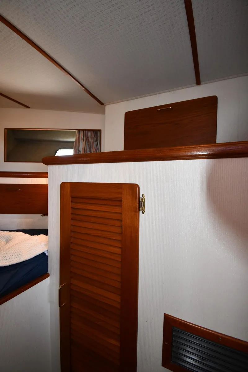 Slide: The Image of Interior cabin of 1988 Tollycraft 34 Sundeck with wooden door and bed. - 30