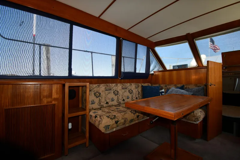 Slide: The Image of Interior of 1988 Tollycraft 34 Sundeck with wooden furnishings and floral upholstery. - 38