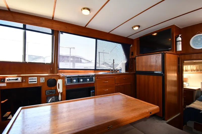 Slide: The Image of Interior of 1988 Tollycraft 34 Sundeck yacht with wooden cabinetry and dining table. - 42