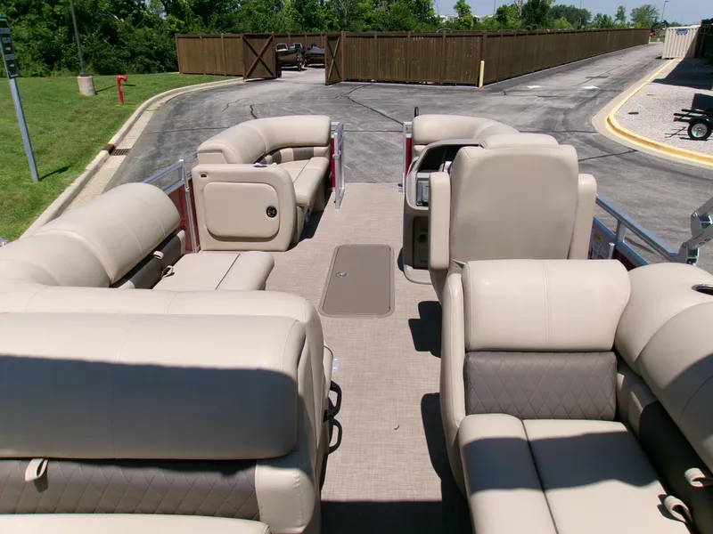 Slide: The Image of 2024 Sun Tracker Party Barge 22 RF XP3 interior with beige seating and spacious layout. - 4