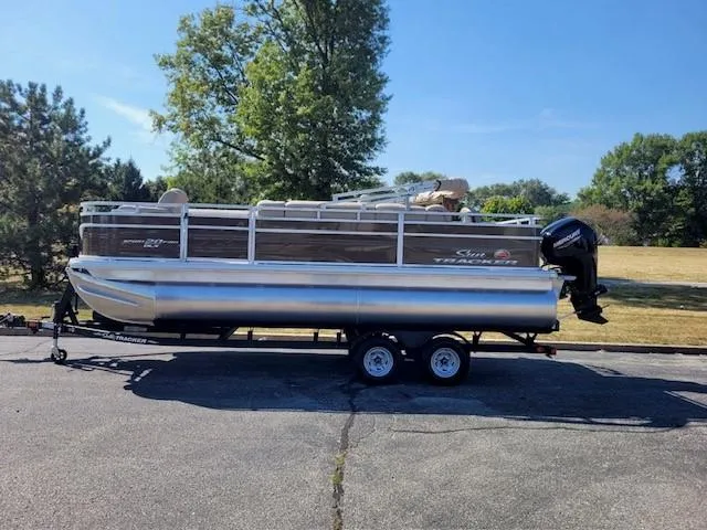 The Image of 2024 Sun Tracker SportFish 20 DLX pontoon boat on trailer, parked outdoors. - 0