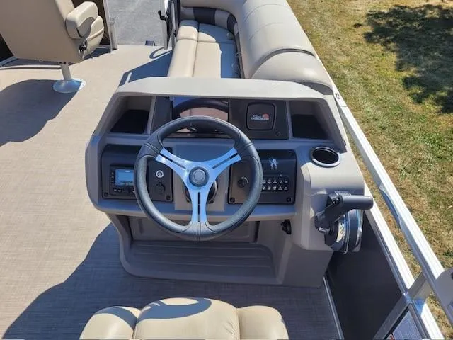 Slide: The Image of 2024 Sun Tracker SportFish 20 DLX boat interior with steering wheel and seating. - 3