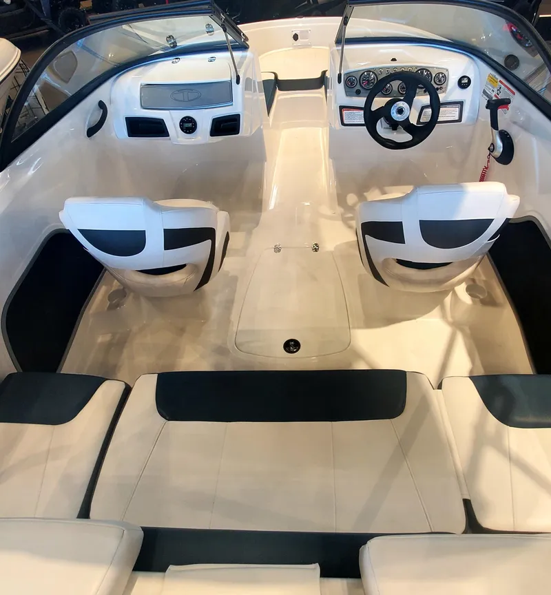 Slide: The Image of 2024 Tahoe 185 S boat interior with white and black seating, steering wheel, and dashboard. - 3