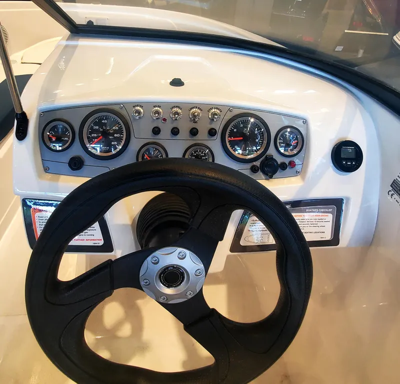 Slide: The Image of 2024 Tahoe 185 S boat dashboard with steering wheel and instrument panel. - 4