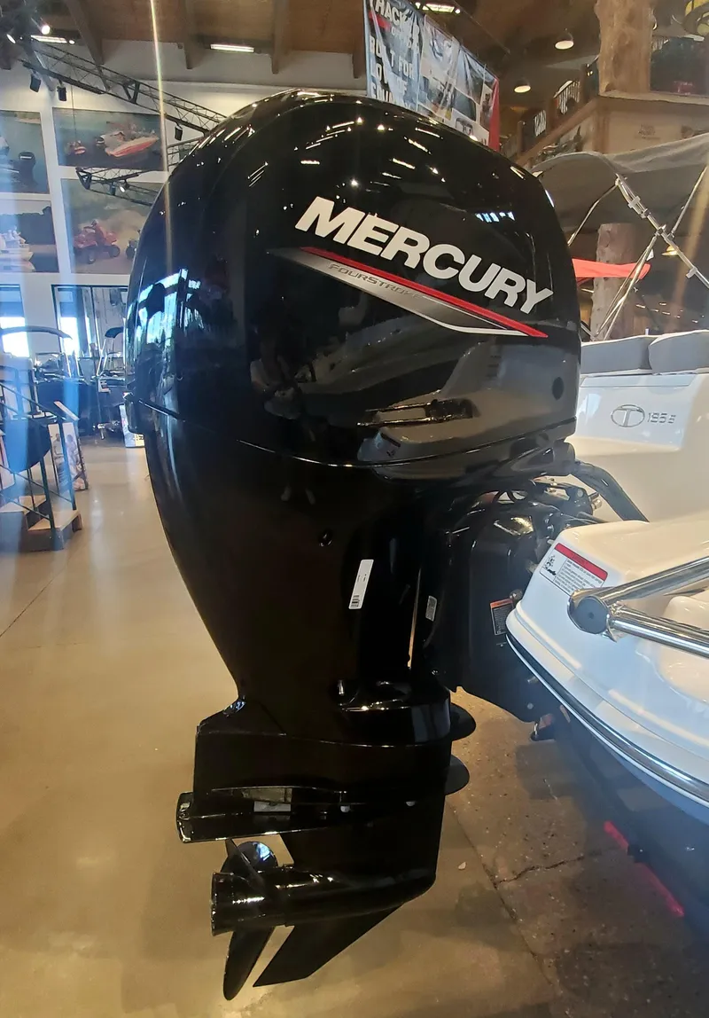 Slide: The Image of 2024 Tahoe 185 S boat with a Mercury outboard motor in showroom. - 6