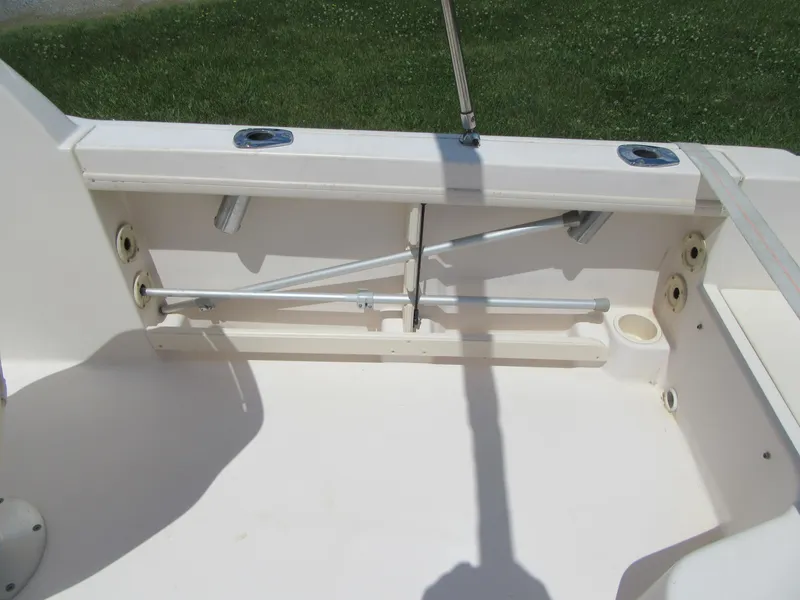 Slide: The Image of 2009 Grady-White Tournament 185 boat interior, showing rod holders and storage compartments. - 10