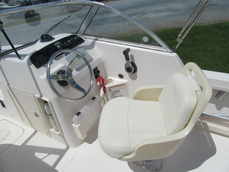 Slide: The Image of 2009 Grady-White Tournament 185 boat cockpit with steering wheel and captain's chair. - 12