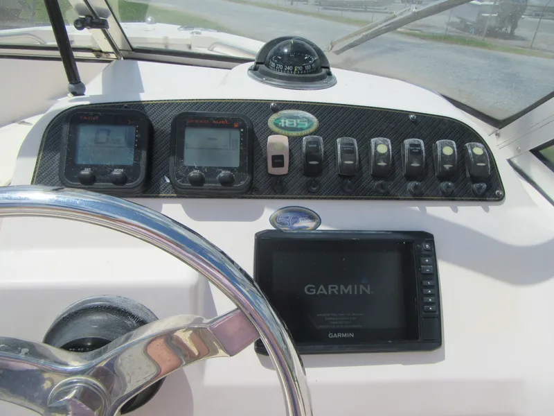 Slide: The Image of 2009 Grady-White Tournament 185 dashboard with Garmin navigation system and control panel. - 14