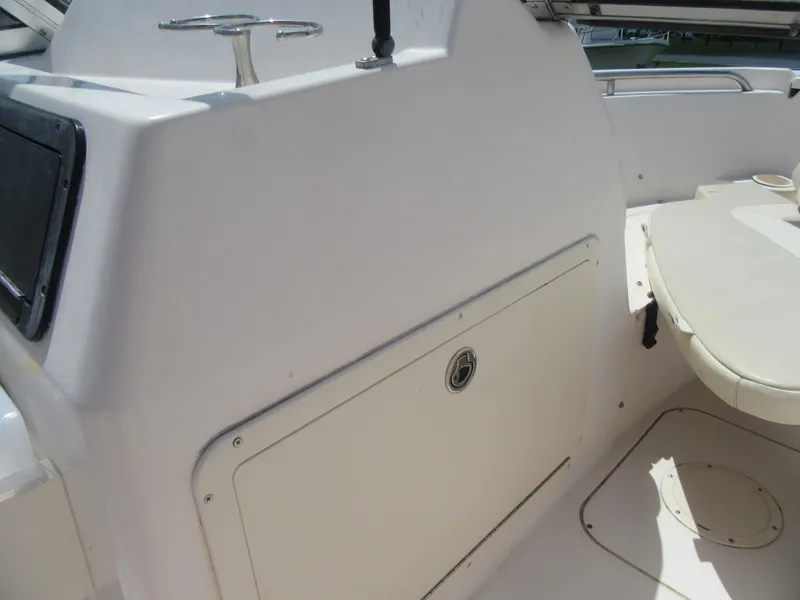 Slide: The Image of 2009 Grady-White Tournament 185 boat interior, featuring storage compartment and seating area. - 17