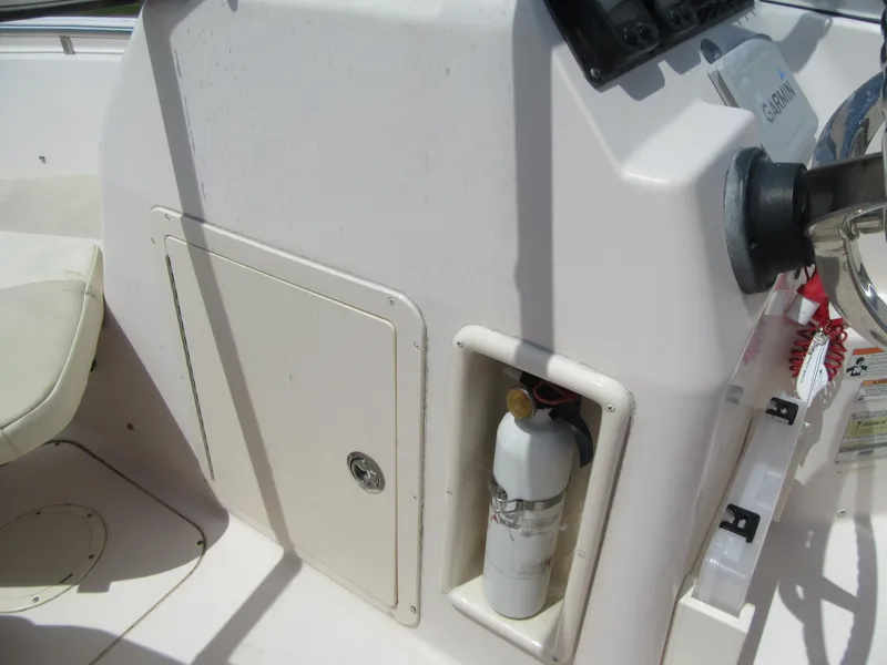 Slide: The Image of 2009 Grady-White Tournament 185 boat console with fire extinguisher and storage compartment. - 18
