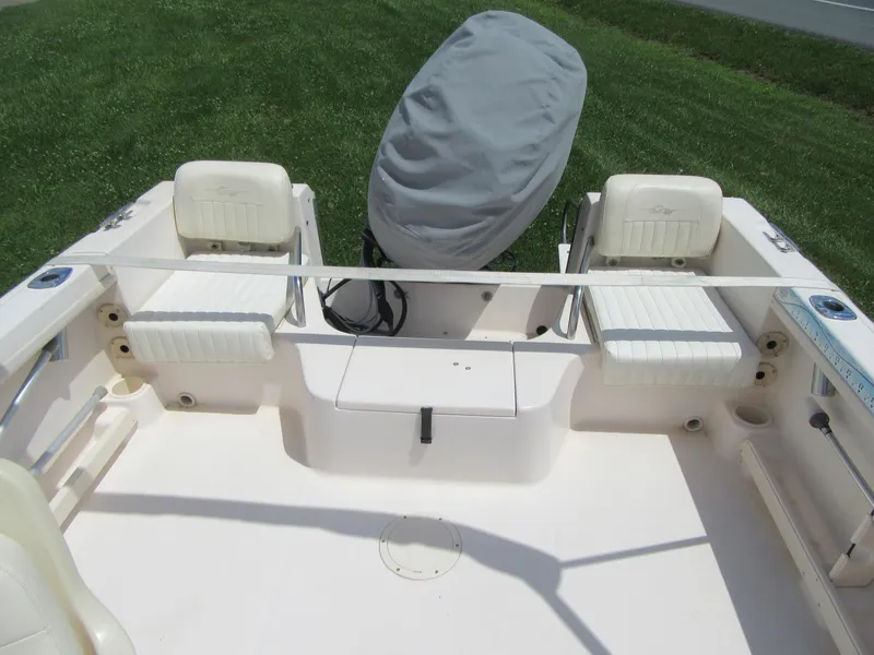 Slide: The Image of 2009 Grady-White Tournament 185 boat interior with covered outboard motor. - 19