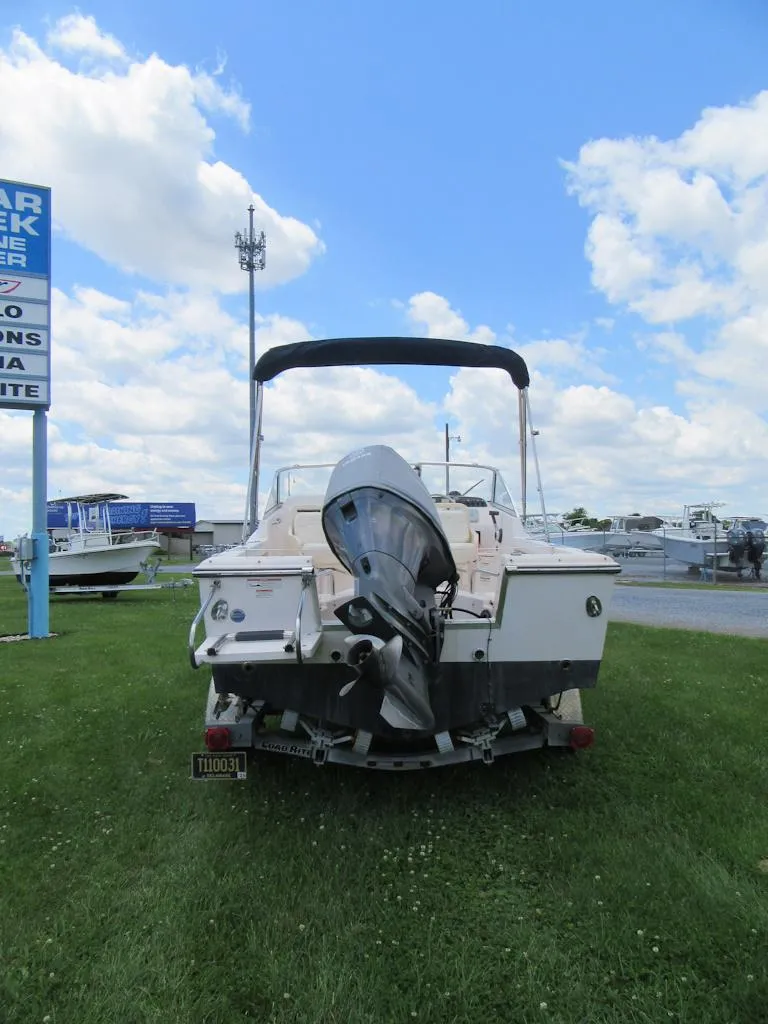 Slide: The Image of 2009 Grady-White Tournament 185 boat with outboard motor on grassy area. - 2