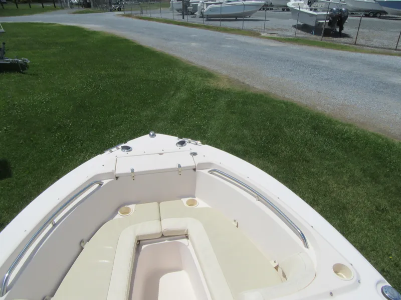 Slide: The Image of 2009 Grady-White Tournament 185 boat with cushioned seating, parked on grass. - 21