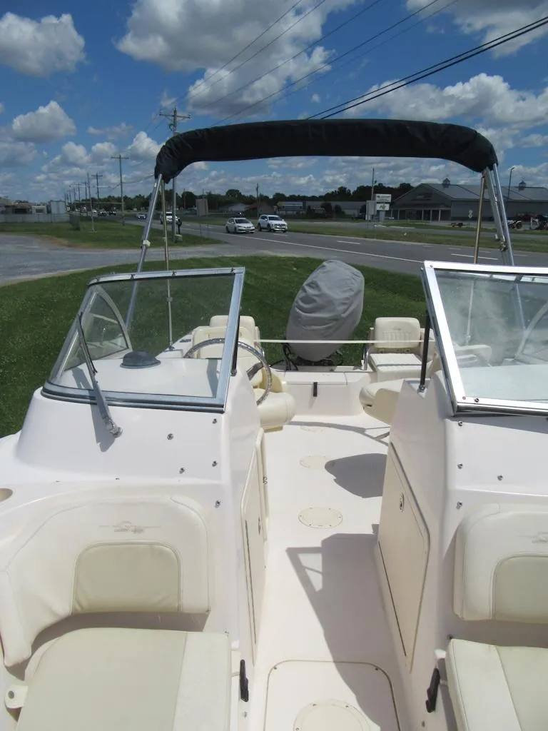 Slide: The Image of 2009 Grady-White Tournament 185 boat with open deck and bimini top. - 22