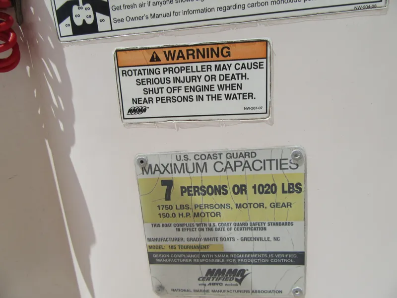 Slide: The Image of Warning and capacity labels on a 2009 Grady-White Tournament 185 boat. - 25