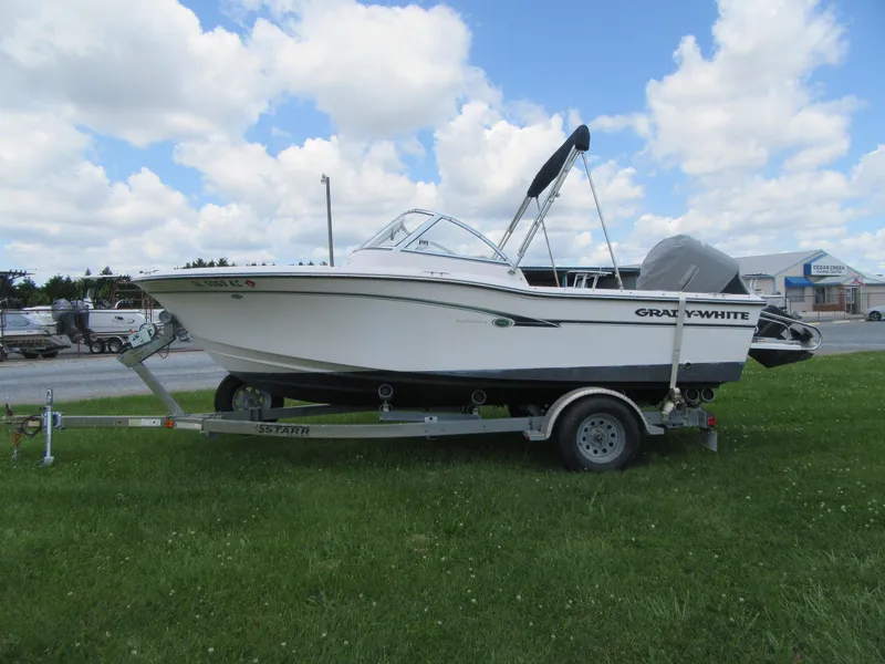 Slide: The Image of 2009 Grady-White Tournament 185 boat on a trailer, parked on grass under a partly cloudy sky. - 3